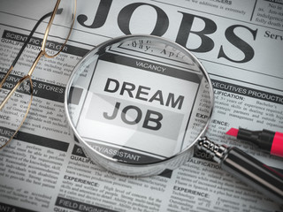 Dream job concept. Job search and employment. Magnified glass with job classified ads in newspaper,