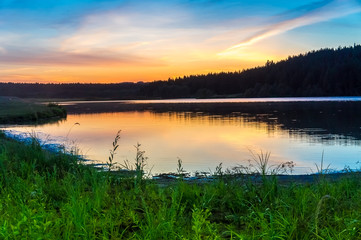 Beautiful lake at sunset in the summer in the countryside