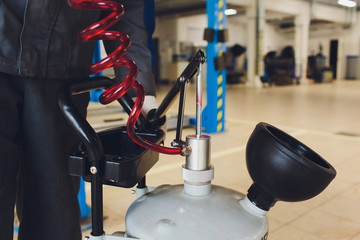 Oil change in automatic transmission. Filling the oil through the hose. Car maintenance station....