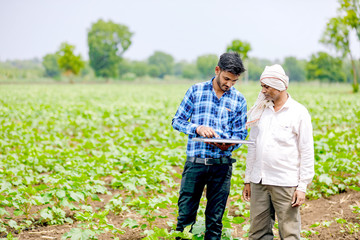 agronomist with farmer at cotton field