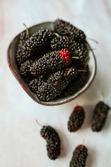 Group of mulberries on marble table. Fresh fruit and vitamin