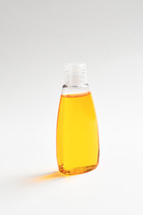 Three plastic bottles with liquid yellow, green and red soap.