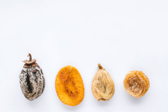 dried fruits lie on a white background, all kinds, rice, dried apricots, peach and grusha.Copy space