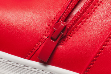 Red metal zipper on red sport boots © hamara