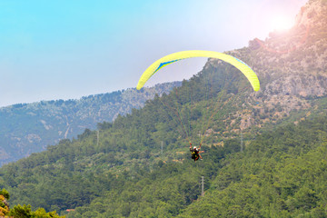 Paragliding. Paraglider on a mountain background.