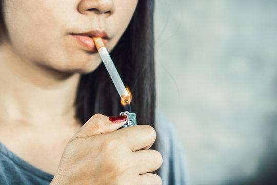 unhealthy Asian woman hand smoking cigarette