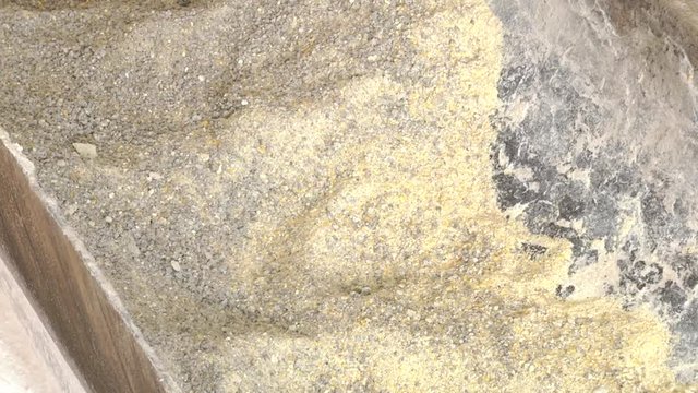 Crushed grains of dried corn and wheat. Livestock feed.