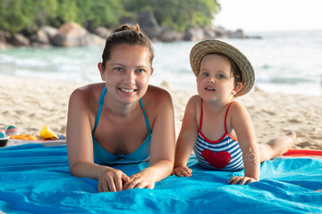 Mother And Daughter Relaxing On The Beach