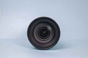 Photography camera lens, front view isolated on pastel background