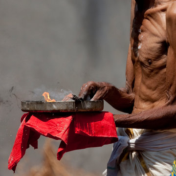 Priest Holding Flames And Ashes In A Plate During Theyyam Ceremony, Thalassery, India