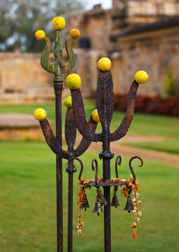 Altar Dedicated To Lord Shiva Maded Of Trishulas Adorned With Fruits, Flowers And Bells At The Brihadishwara Temple, Gangaikondacholapuram, India