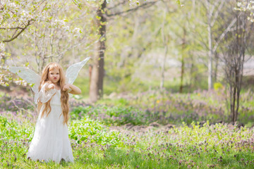Fototapeta na wymiar Cute little Angel Fairy girl gets angry and fights