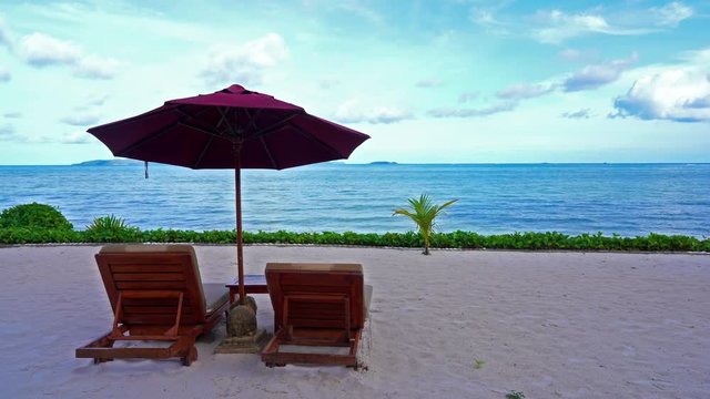 Beach sets of deckchairs and umbrella overlooking the sea
