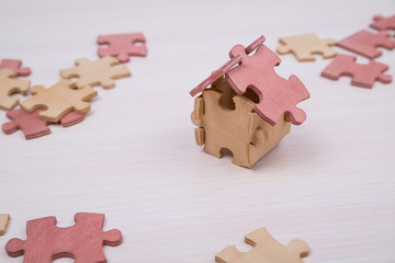 The house is made up of pieces of puzzles, Concept eco house. buying a house, renting out, selling...