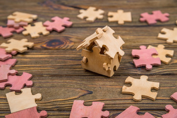 house of wooden pieces of puzzles. creative idea, business concept, construction, sale, mortgage, credit. Family Eco House