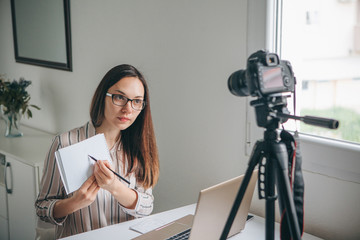 Girl blogger records video for their subscribers. Infobusiness or information business or hobby or...