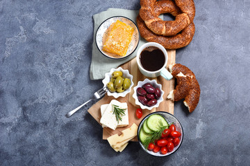 Traditional turkish breakfast with olives, simit bagels, feta cheese, coffee, honey combs, oriental snack - obrazy, fototapety, plakaty
