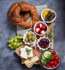 Traditional turkish or oriental snack, breakfast with olives, simit bagels, feta cheese, stuffed wine leaves