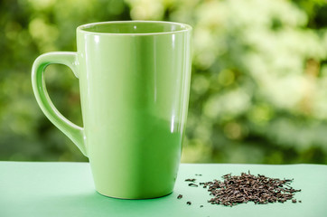 green cup of tea on a beautiful green background