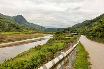 asphalt mountain road along the river, Dien Bien province, Vietnam