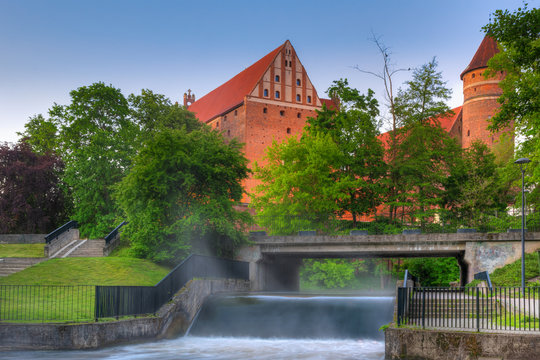 Early morning - view of the Olsztyn castle from the park. Lyna River; Warmia, Poland.