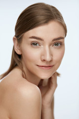 Fototapeta premium Beauty face. Woman model with healthy natural skin on white