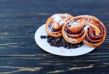 Rustic with black current berry pie on black wooden background.