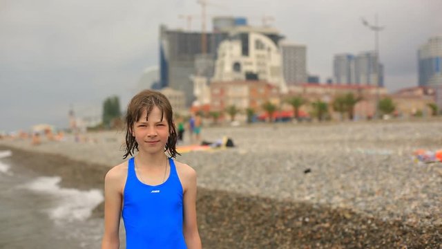 portrait of a teenage girl on the beach by the sea