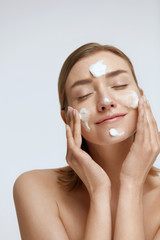 Face skin care. Woman cleaning facial skin with foam soap