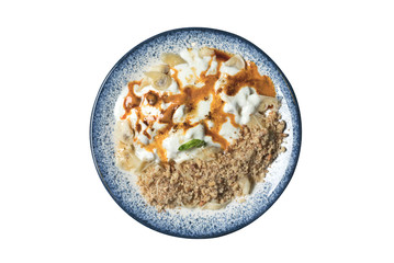 Traditional Turkish meat pasty with yoghurt,sauce,spices and walnuts in a blue colored dish on a white isolated background 