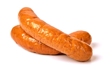 Meat sausages with glitter on a light background. Boiled sausages. The concept of traditional cuisine.