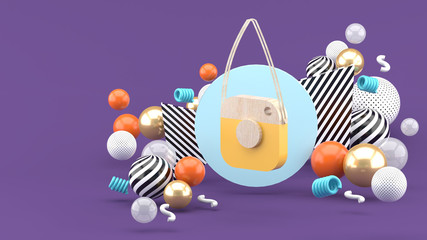 A good DIY camera on a blue circle among colorful balls on a purple background.-3d rendering.