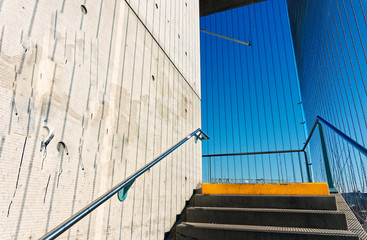 Staircase in a public overpass with concrete and steel and bars