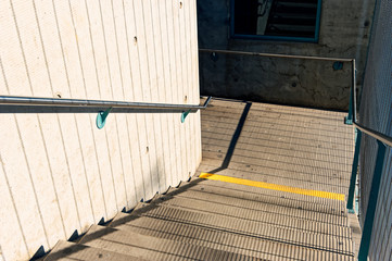 Obraz premium Staircase in a public overpass with concrete and steel and bars
