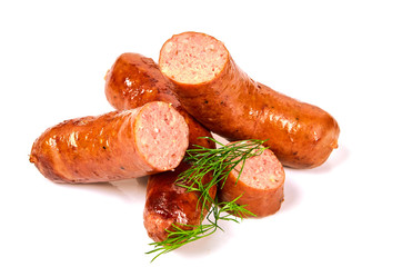 Grilled sausages with onions on a Board on a light background. Juicy sausage rings in a pile on a white background.
