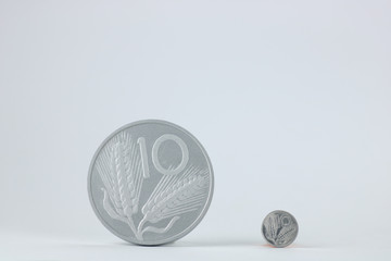 small and large coin of  ten old  italian lira on white background, copy space
