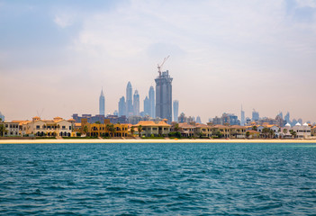 Dubai Marina skyscrapers and villas on the Palm Jumeirah. Luxury properties of UAE