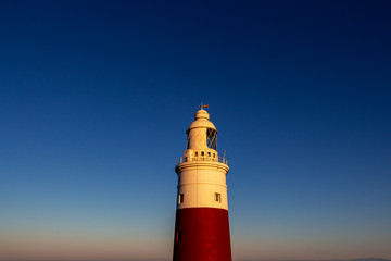 Exterior partial view of Europa Point Lighthouse, Trinity Lighthouse at Europa Point or Victoria Tower in Gibraltar at sunset