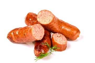 Grilled sausages with onions on a Board on a light background. Juicy sausage rings in a pile on a white background.
