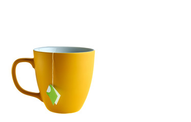 Yellow cup with tea pack on white background