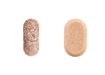 Two brown oval pills isolated on white background