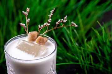 Beautiful white cocktail based on Jack Daniels Honey, milk and macadamian syrup with ice in a...