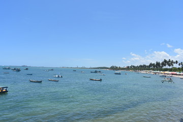 Boats near the shore with port behind