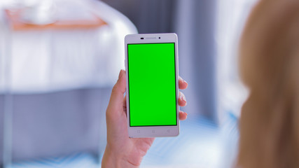 hand holding smart phone with icons