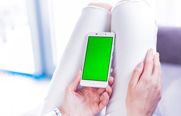 woman using digital mobile phone inthe room