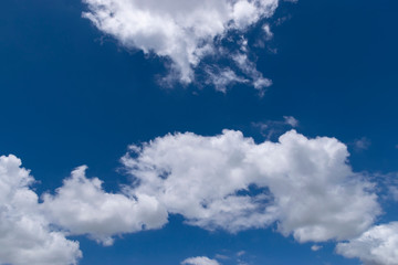 Naklejka na ściany i meble Fluffy White Clouds Floating in a Beautiful Blue Sky 01