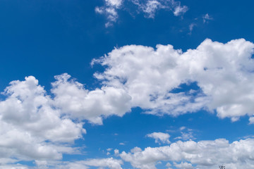 Naklejka na ściany i meble Fluffy White Clouds Floating in a Beautiful Blue Sky 03