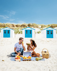 couple picnic on the beach, beach house Texel netherlands, men and woman having lunch on the beach