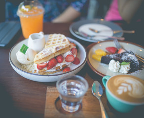 Latte hot coffee with many desert of waffle and chocolate cake