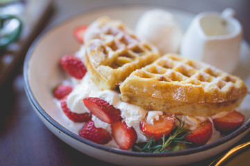 waffle pancake desert with vanilla ice cream, fresh strawberry and honey syrup